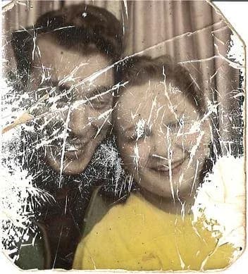 Scratched and damaged old family photo before AI restoration with RestorePhotosApp